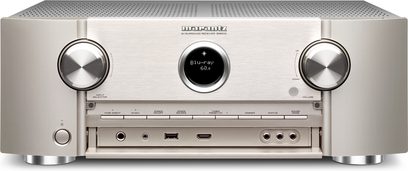Marantz SR6010 sølv-guld hjemmebiograf-forstærker, forsiden er sølvfarvet med knapper og blå LCD-skærm, 3 sølvfarvede drejeknapper