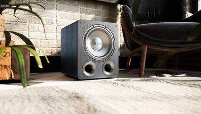 SVS PB-1000 PRO baskabin i sort ask, sort askefinish, set forfra, placeret på gulvtæppe, træinteriør, læderlænestol