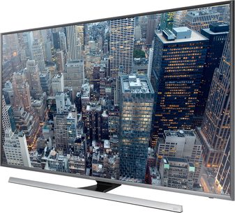 Samsung UE65JU7000 fladskærms-TV med billede af luftfoto over skyskrabere i en storby om natten