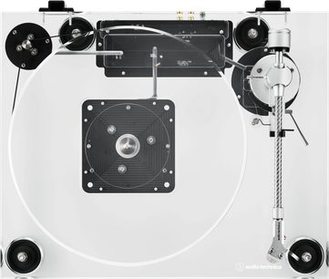 Hvid Audio Technica AT-LPA2 vinylpladespiller i akryl med gennemsigtigt rundt pladetallerken og sølvfarvet metal-tonearm til højre, set ovenfra