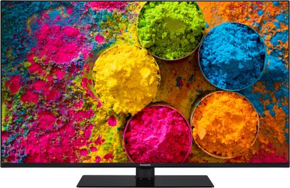 Panasonic TX-43MX700E-fladskærm, der viser et farverigt billede af bobler eller cirkler i forskellige størrelser og klare, levende farver