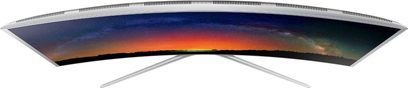 Samsung UE55JS9000 buet TV, set forfra, slukket skærm der reflekterer en orange og blå solnedgang