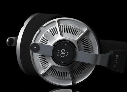 Close-up side view of an open silver metal headset, radial grille, black cushion, end logo, L and DX6000 markings