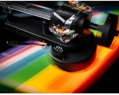 Pro-Ject The Dark Side Of The Moon Hi-Fi Turntable, metallic tonearm, black counterweight, tracking force adjustment marked 1.5-2.5, surface with rainbow-patterned design