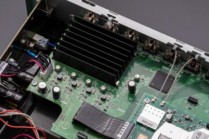 Carte électronique verte avec composants électroniques, radiateurs en aluminium et connecteurs, vue rapprochée de dessus