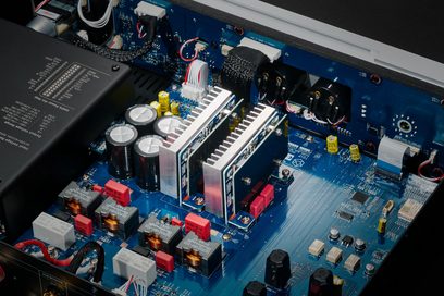 Стерео підсилювач Hi-Fi Rose RA280 чорний. Зблизька внутрішня частина, що показує електронні компоненти на синій друкованій платі