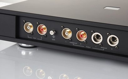 Rega Aura MC black phono preamp, rear view, 6 gold-plated RCA connectors, 2 switches, text "Input", "Earth", "Output"
