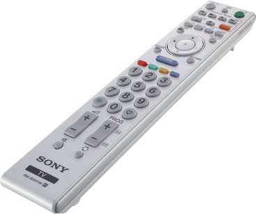Grå Sony RM-ED011 fjernbetjening med knapper i flere farver, set forfra, liggende fladt