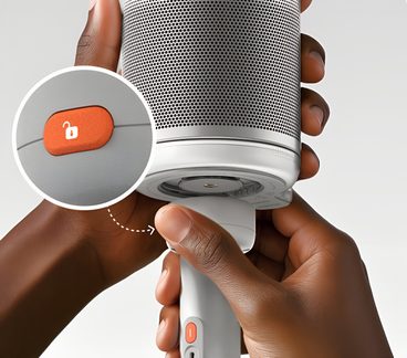 Hvidt cylindrisk apparat i plast, perforeret gitter, set nedefra, orange knap med ikon af åbent hængelås