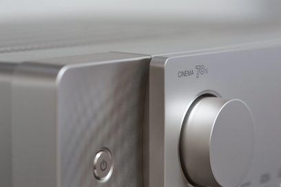 Marantz Cinema 70s gümüş renkli ev sinema sistemi, ön panel yakın çekim, güç düğmesi ve ses kontrol düğmesi