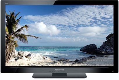Panasonic TX-LF37E30 fladskærms-TV, der viser et tropisk strandmiljø med palmer, klipper, hvid sand og turkisblåt hav under en let skyet himmel