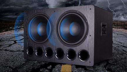 Black dual home theater subwoofer with front ports set on cracked asphalt under a stormy sky