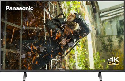Panasonic TX-55HX900E 4K HDR-fladskærm, der viser en skovscene med tæt på visning af blade og grene