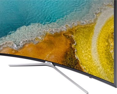 Samsung UE49K6300AKXZF TV-skærm, der viser en gul sandstrand og et turkisfarvet hav, set fra siden, med metalfod