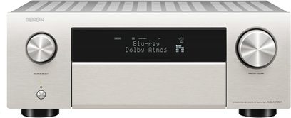 Wzmacniacz kina domowego Denon AVC-X4700H w kolorze srebrnym, widok z przodu, niebieskie wyświetlanie "Blu-ray Dolby Atmos", dwie obrotowe srebrne gałki