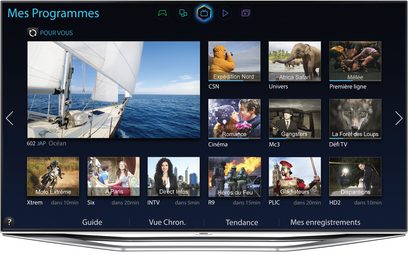 Samsung UE60H7000-fjernsyn, der viser en brugergrænseflade med miniaturebilleder af forskellige tv-programmer