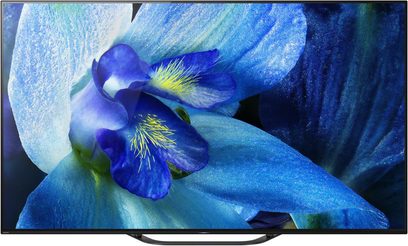 Sony KD-55AG8 TV viser et nærbillede af en blå blomst med translucente kronblade på en mørkeblå baggrund