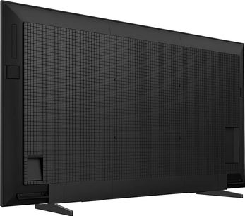 Televizor Sony BRAVIA 5 K75XR5 s vysokým rozlišením v matné černé barvě s texturovaným plastem a mřížkou, pohled zezadu z levého tříčtvrtečního úhlu s široce rozkročenými kovovými nohami