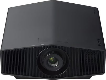 Sony BRAVIA Projector 7 — VPL-XW5100ES sort, mat sort plastkabinet, centralt placeret linse omgivet af blank sort ring, indbygget i en front med fine lodrette gitre, set let oppefra forfra