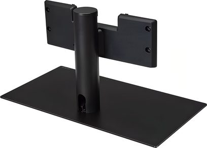 Sort LG ST-G4SN65 vægbeslag til TV i metal, set bagfra i let fugleperspektiv, består af en flad, rektangulær base, et hult cylindrisk rør med kabelgennemføring og en vandret plade med fire monteringshuller