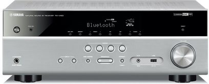 Yamaha RX-V483 titanium home theater amplifier, front view, blue display, silver buttons and knobs, headphone jack on the right