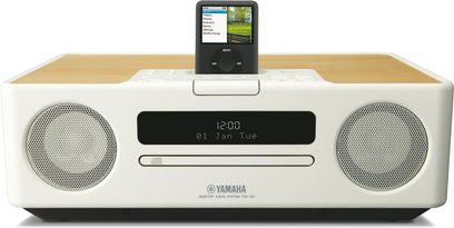 Yamaha TSX-130 Creme-Weiß-Radio, Frontansicht, LCD-Display zeigt "12:00", iPod-Dockingstation, integrierte Stereo-Lautsprecher
