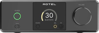 Preamplificator de căști high-fidelity Rotel DX-3 negru, cu carcasă metalică, vedere din față, ecran central iluminat din spate cu indicator circular, buton mare de volum în dreapta și buton de pornire încercuit cu verde în stânga