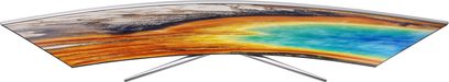 Samsung UE65MU9005 buet TV set forfra, tændt skærm der viser et farverigt landskab med varme og kolde toner
