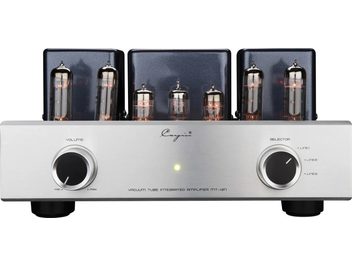 Vista frontale di un amplificatore integrato stereo a valvole Cayin MT-12N, pannello frontale in alluminio spazzolato color argento con due manopole nere con bordo metallico, indicatore LED verde centrale e sei valvole in vetro incandescente allineate davanti a tre coperture di trasformatori in metallo nero metallizzato
