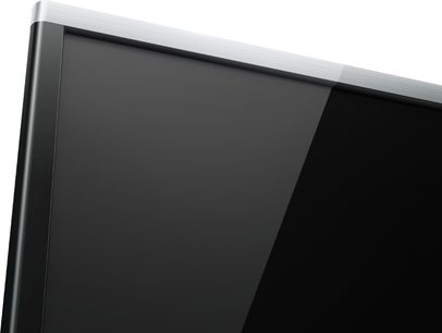 Panasonic TX-60AS650E fladskærms-tv, sort slukket skærm, blank sølvfarvet ramme, nærbillede af øverste højre hjørne