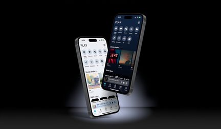 Two gray smartphones made of metal and glass, with edge-to-edge screens and a pill-shaped front cutout, floating in a three-quarter front view—one displaying a light interface and the other a dark interface