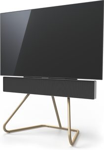 Designmøbel til fladskærms-TV i sort og gylden metal med buede, rørformede ben, set fra en trekvartvinkel