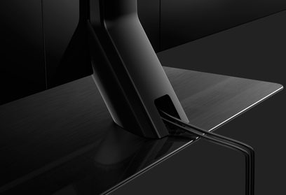 Panasonic TX-55FX740 fladskærms-TV set fra siden, skærm slukket, X-formet metalfod, slank og elegant design