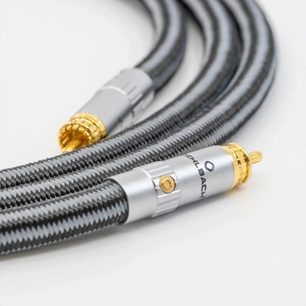 Oblique close-up of the Oehlbach Sub Xtreme subwoofer cable in black with braided sleeve, silver-plated metal male RCA connectors with gold-plated tips and screws