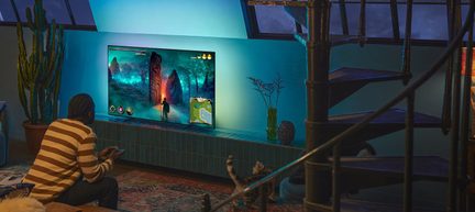 Black flat-screen TV, slim metal frame, turquoise blue backlight halo, front view