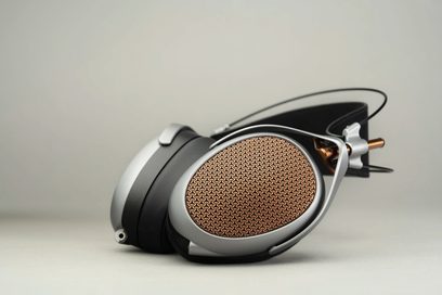 Åbne kablede hi-fi-hovedtelefoner Meze Audio Poet, sidevisning, højre ørekop med gyldent metalgitter i geometrisk mønster, sort hovedbøjle