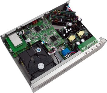 Top view of an open Primare CD21 CD player, showing green electronic circuits and electronic components visible