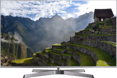 Telewizor Panasonic TX-50EX780E wyświetlający górski krajobraz z kamiennymi ruinami na pierwszym planie
