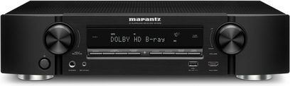 Amplificador de cine en casa Marantz NR1506 negro, vista frontal, pantalla que muestra "DOLBY HD B-ray", botones y tomas en la parte delantera, 2 ruedas plateadas