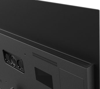 Panasonic TV-55Z90B high-definition television in black, matte metal casing, rear view from a slight side angle, showing slim profile, long top ventilation grille, and recessed rectangular module with three circular speakers