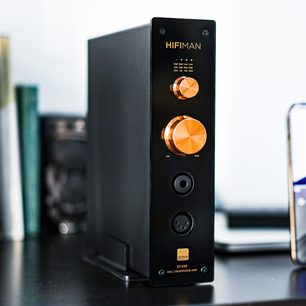 High-fidelity headphone preamp Hifiman EF499, front view, black casing, 2 orange control knobs, 2 jack sockets, 1 XLR socket