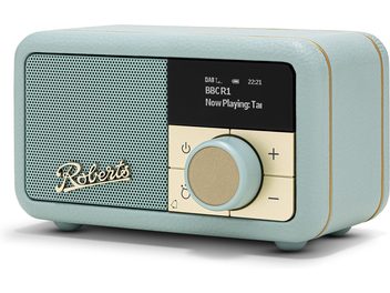 Sky blue Roberts Revival Petite 2 tabletop radio in textured faux leather, three-quarter front-right view, with large perforated grille, black digital display, and gold knob