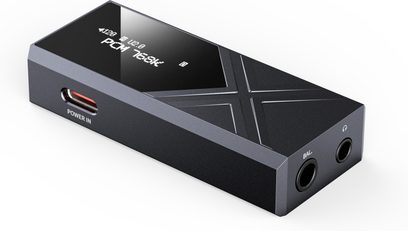 FiiO KA17 draagbare audio-omzetter zwart, rechthoekige behuizing van mat aluminium, glanzend scherm aan de bovenzijde met gegraveerd X-motief, licht van bovenaf in perspectief weergegeven, met aan de zijkant een rode USB-C Power In-poort en aan de voorkant twee ronde hoofdtelefoonaansluitingen