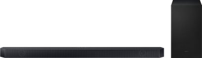 Samsung HW-Q710D soundbar i mat sort med subwoofer, akustisk gitter, LED-skærm, på mørkegråt bord