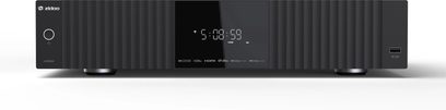 Reproductor multimedia UHD8000 Zidoo, vista frontal, caja rectangular negra, pantalla central mostrando la hora, patas circulares, puerto USB a la derecha