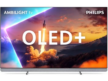 Philips 65OLED910 högupplöst TV i svart med ultratunn metallram, frontmonterad soundbar i ljusgrått tyg och två låga metallfötter, sedd framifrån