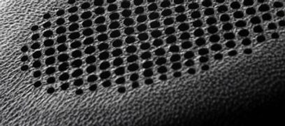 Perforeret sort metalgitre i heksagonalt mønster, der dækker den åbne hovedtelefon Bowers & Wilkins P5, tæt på-billede