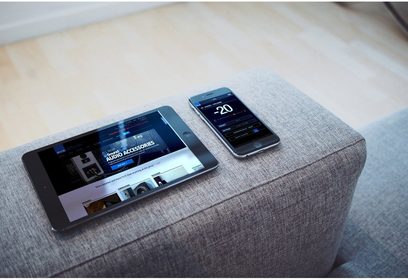 SVS PB-4000 sort lakeret baskabin og smartphone, der viser skærmen "-20", placeret på et lyst gråt stof