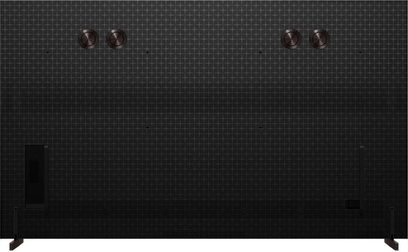 TCL 85X11L-fjernsyn set bagfra i sort med ternet mønster, sidefødder og fire cirkulære skiver