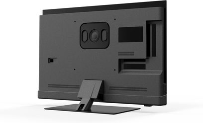 Panasonic TV-42Z90BE6 high-definition television, matte black with plastic casing, flat metal table stand, rear view at a slight angle showing central mounting plate, slim ventilation slots, and side compartment for connectors